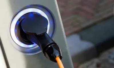 Modern electric car charging at home using a solar-powered EV station installed by NeighborSun in LA.